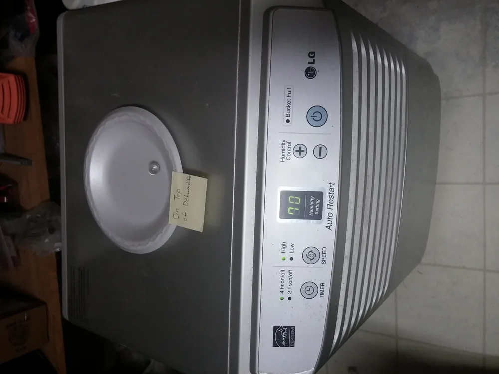 HEPA air scrubber and dehumidifier running in a treated room